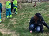 Girl sitting in grass in front of a crane