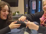 Mette helping Leyla with knitting