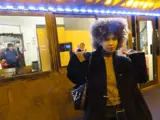 girl standing in front of a kiosk